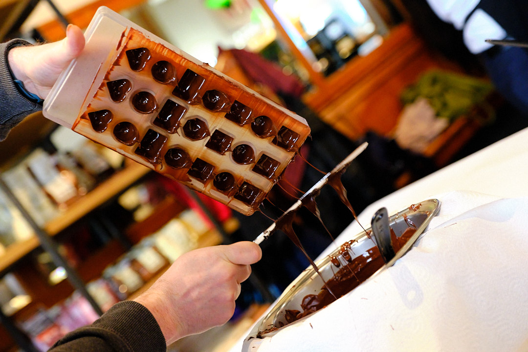 praline making in process, chocolate drops from the mold